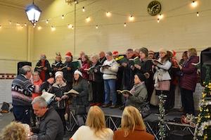 Carol Singing at the Twilight Market in the Trestle Market in Leek